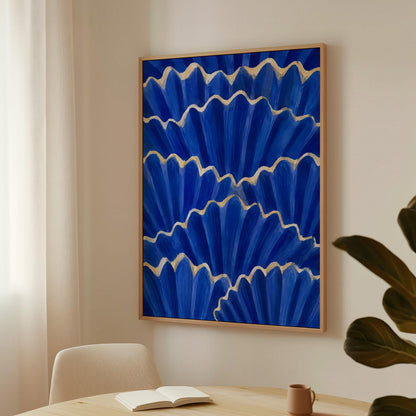 Fan shaped scallop shells in cobalt with gold edges, canvas wall art hanging in a calm, modern living space