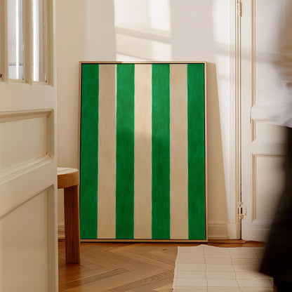 Bold vertical cabana stripes in emerald green and cream, canvas wall art on a quiet wall in a considered interior