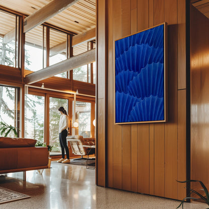 Overlapping pleated fan shapes in deep royal blue, canvas print shown in a sunlit, contemporary room