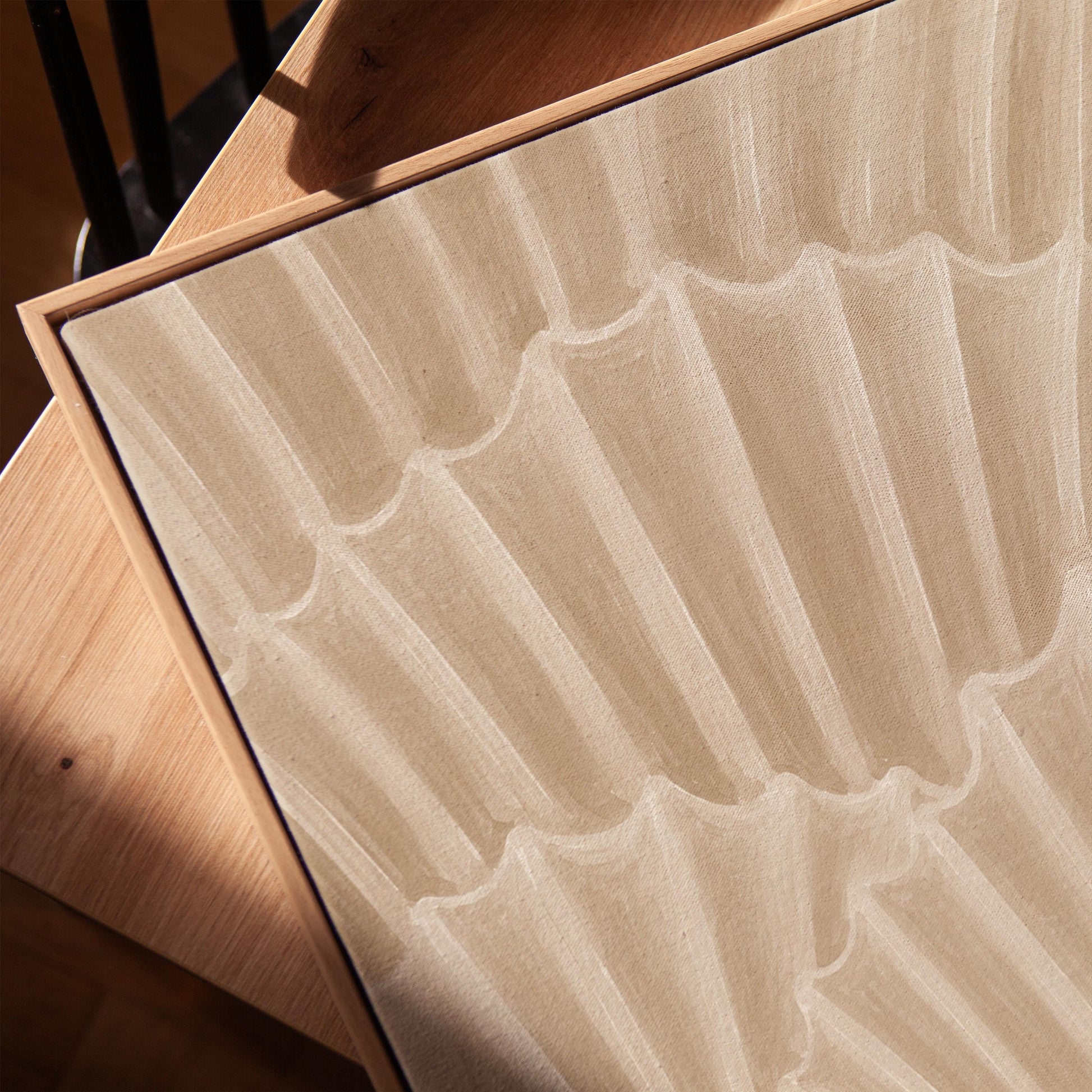 Overlapping fan shells in warm sand and taupe, canvas print in a warm, minimally styled interior