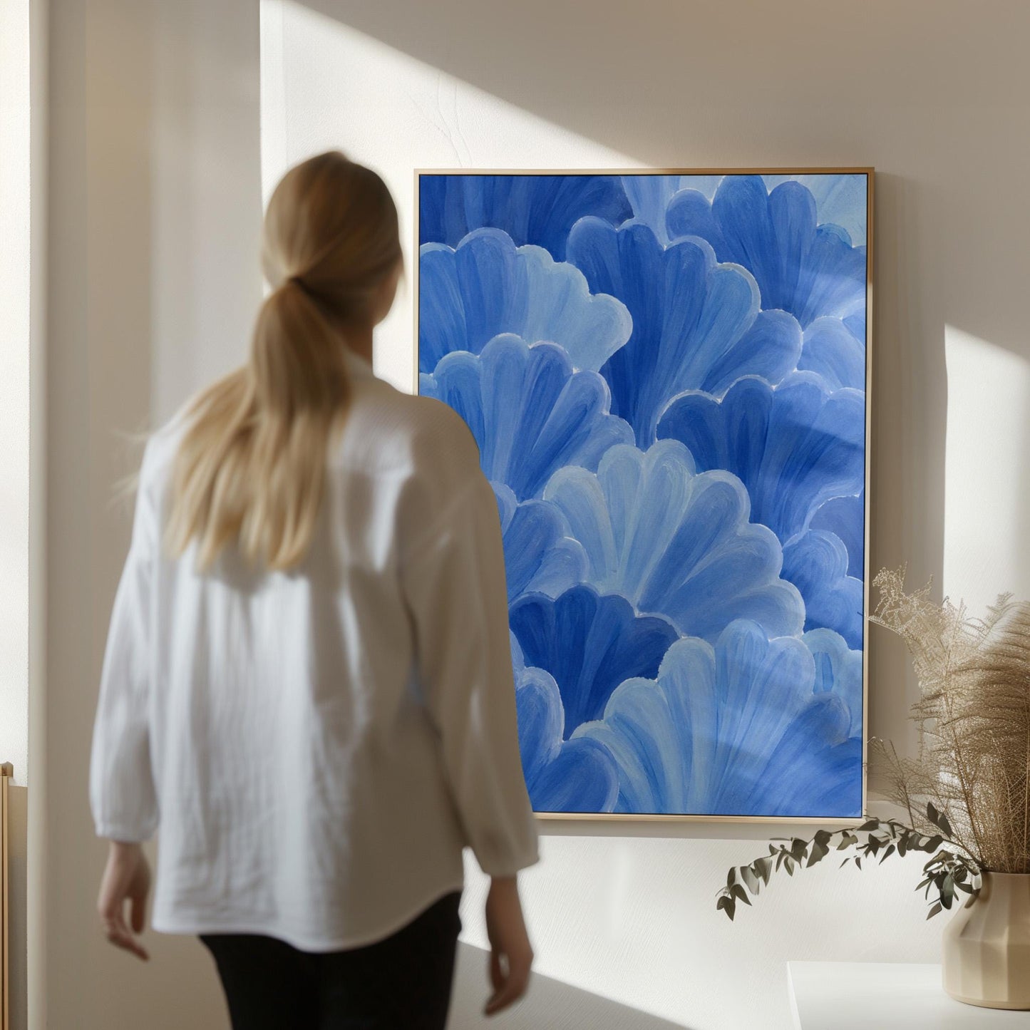 Petal fan clusters in cornflower and powder blue, canvas wall art hanging in a calm, modern living space