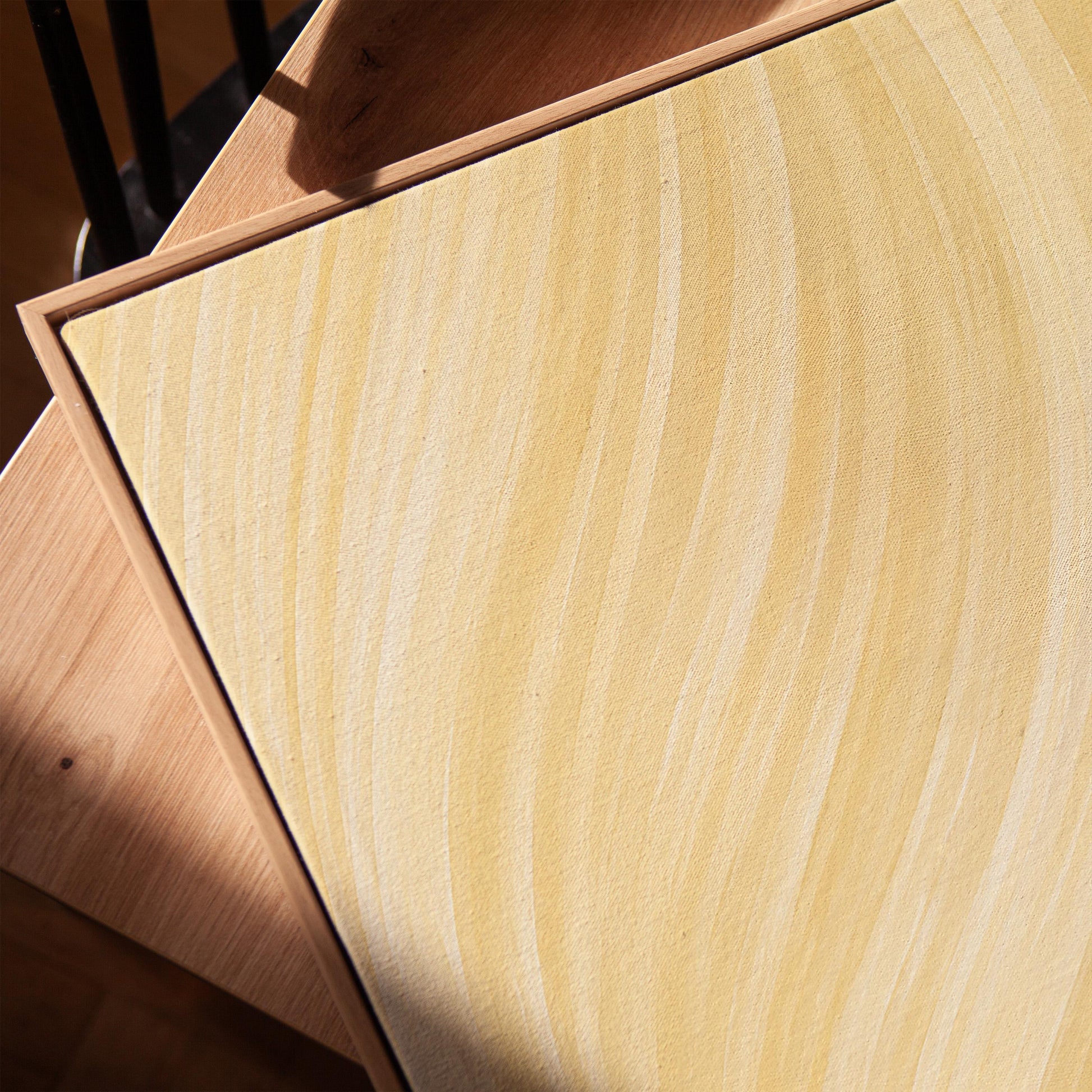 Flowing honey gold waves with soft warm glow, canvas print in a warm, minimally styled interior