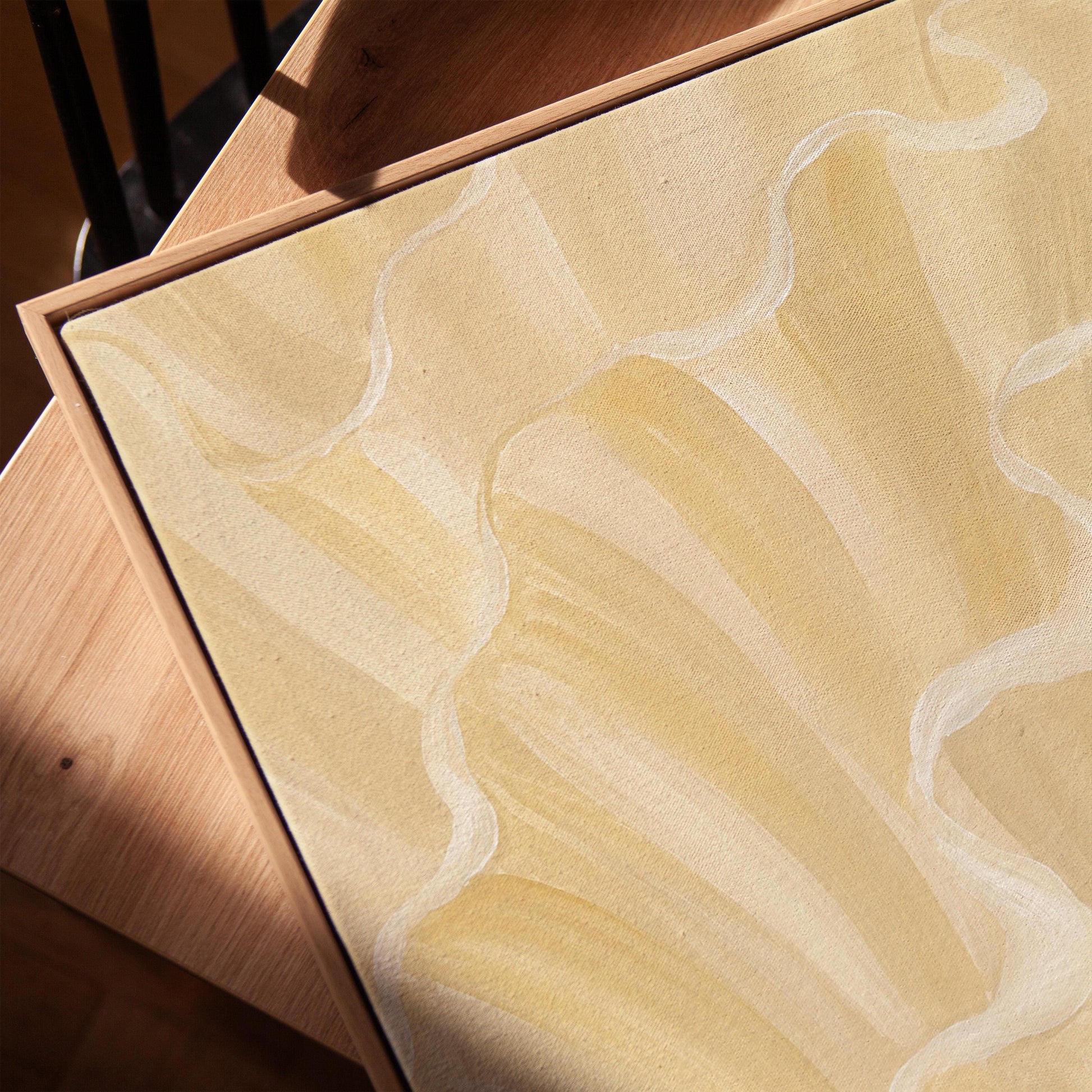 Ruffled wave folds in champagne cream and gold, canvas print in a warm, minimally styled interior