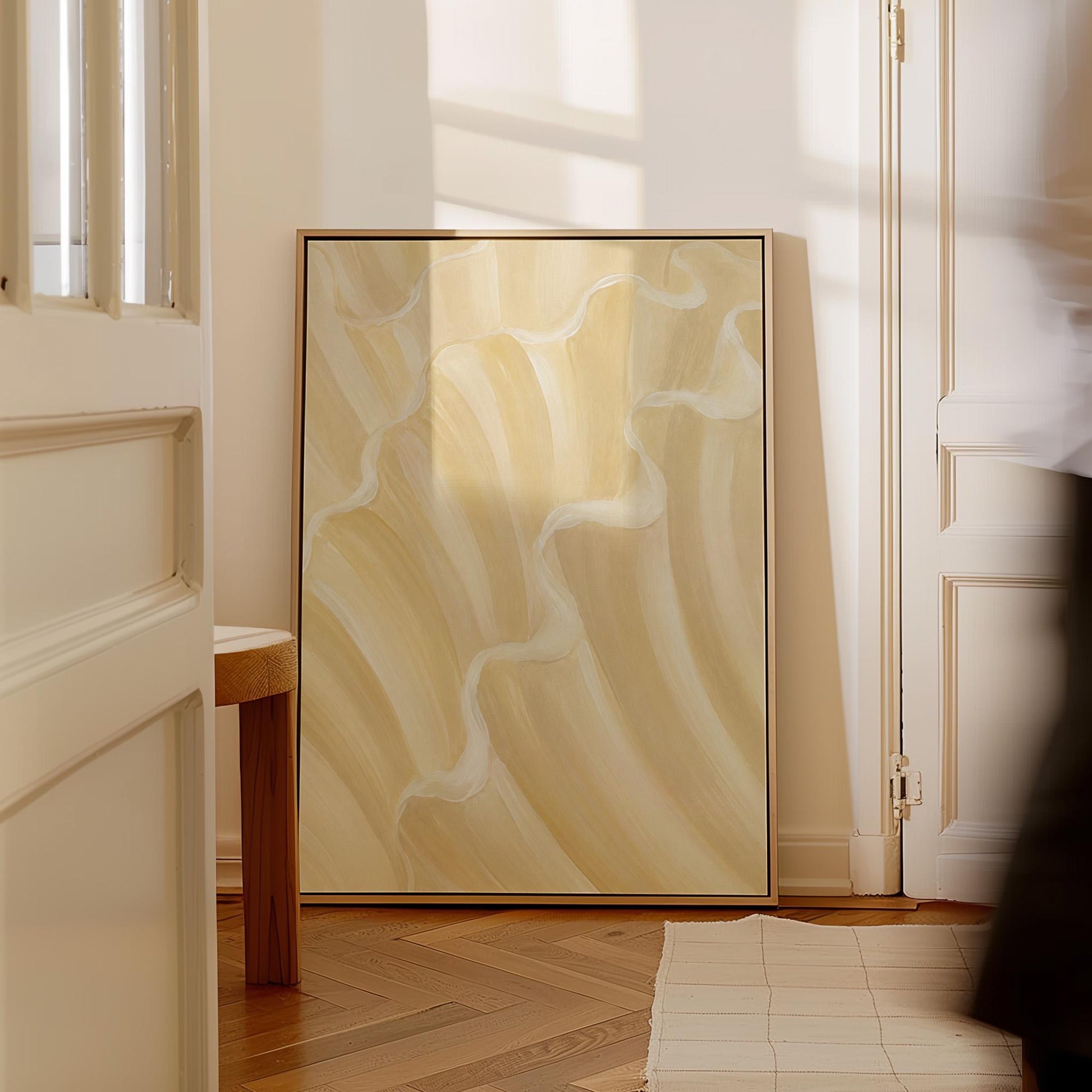 Ruffled wave folds in champagne cream and gold, canvas print styled against a soft white wall