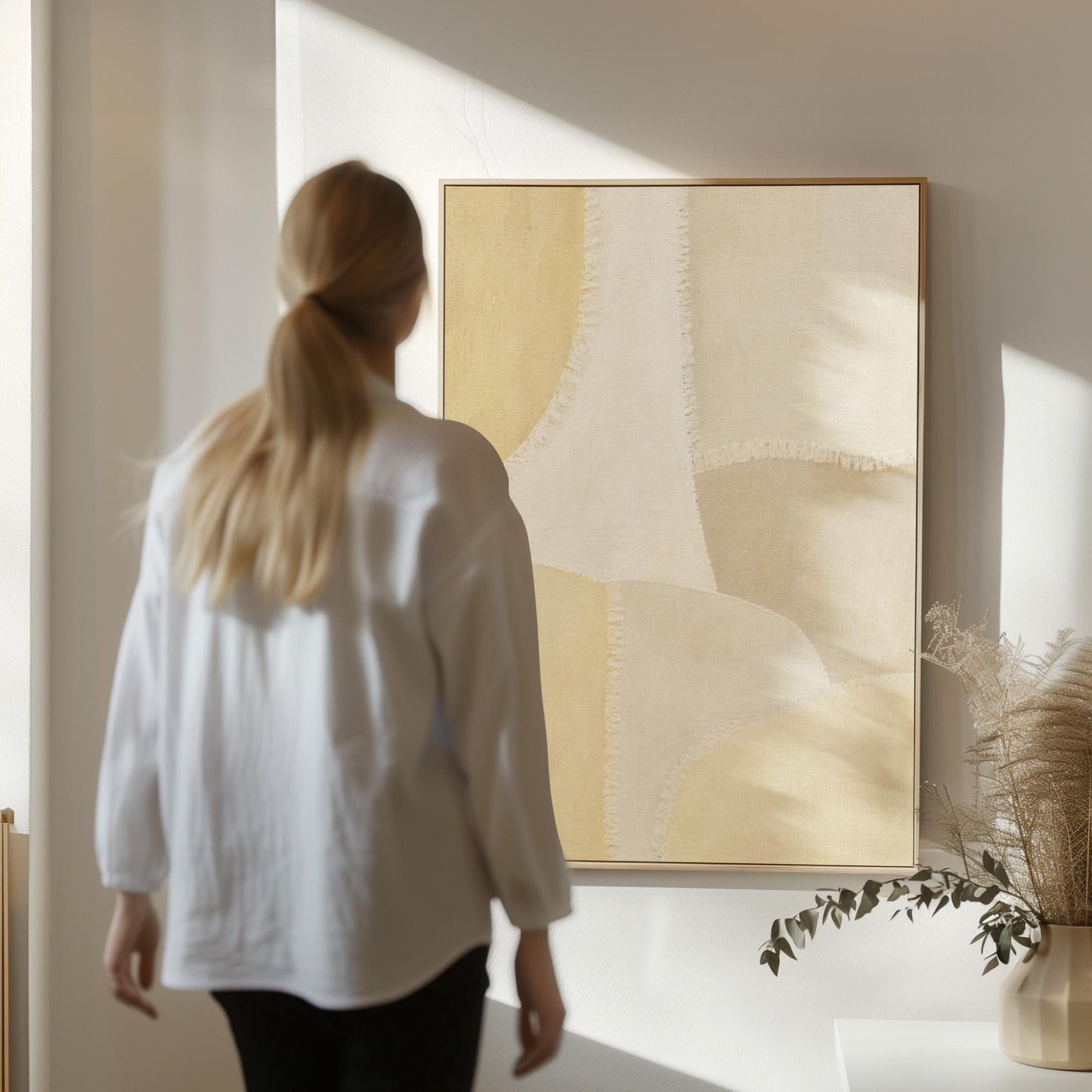 Soft tonal beige blocks joined by delicate stitch lines, canvas print displayed on a neutral wall in a styled interior