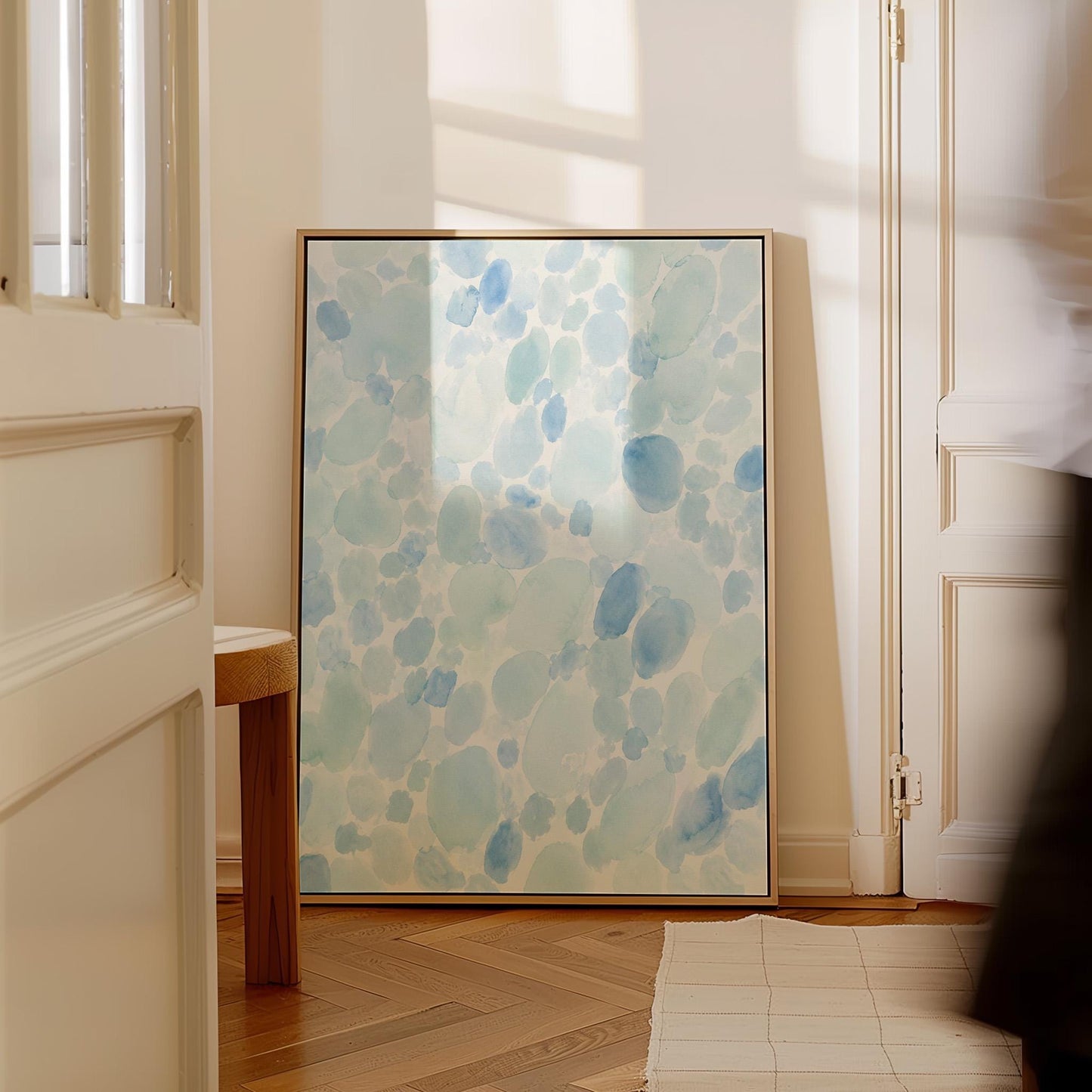 Dappled watercolor petals in light baby blue, canvas print shown to scale in a furnished room