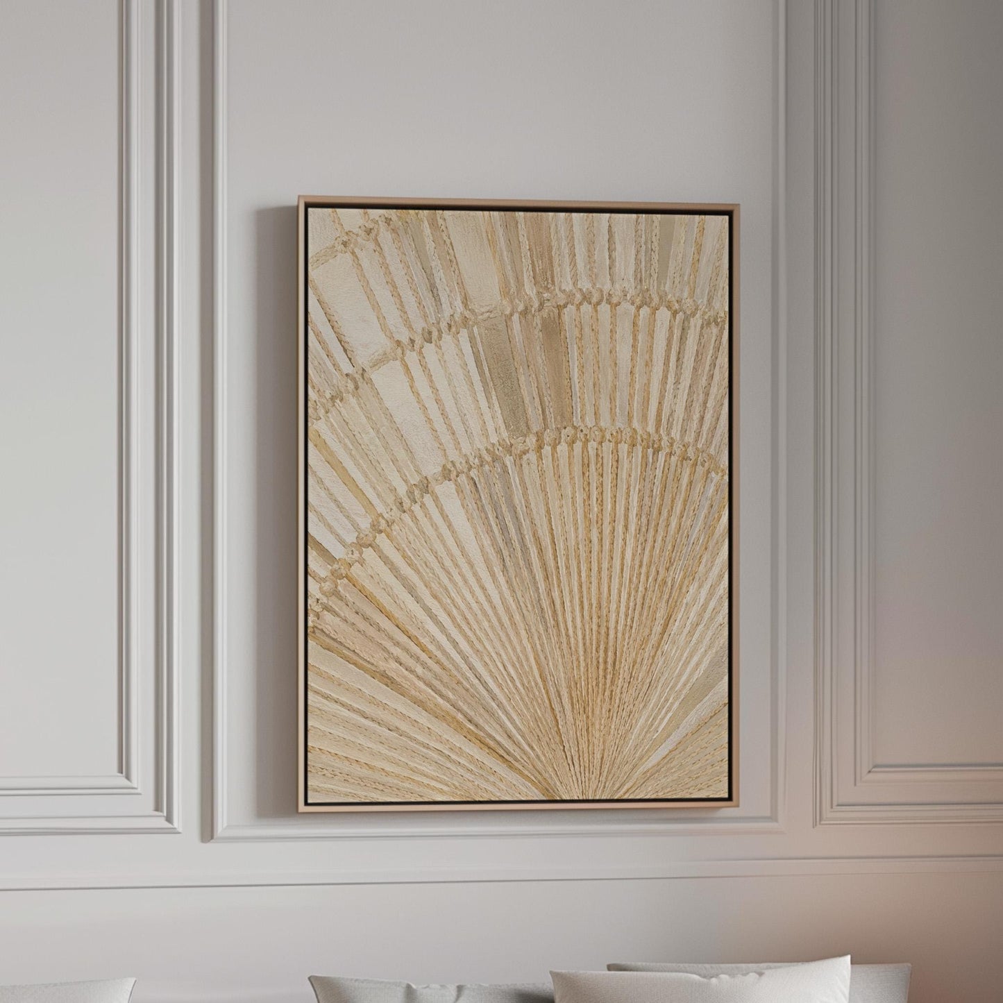 Golden fan palm leaf with radiating rays on cream, canvas print in a bright room with natural daylight