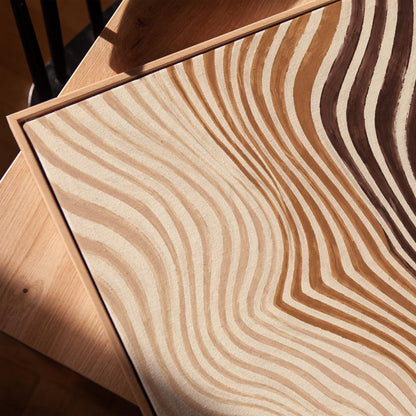 Wavy line pattern fading from beige to rust and brown, canvas print in a warm, minimally styled interior