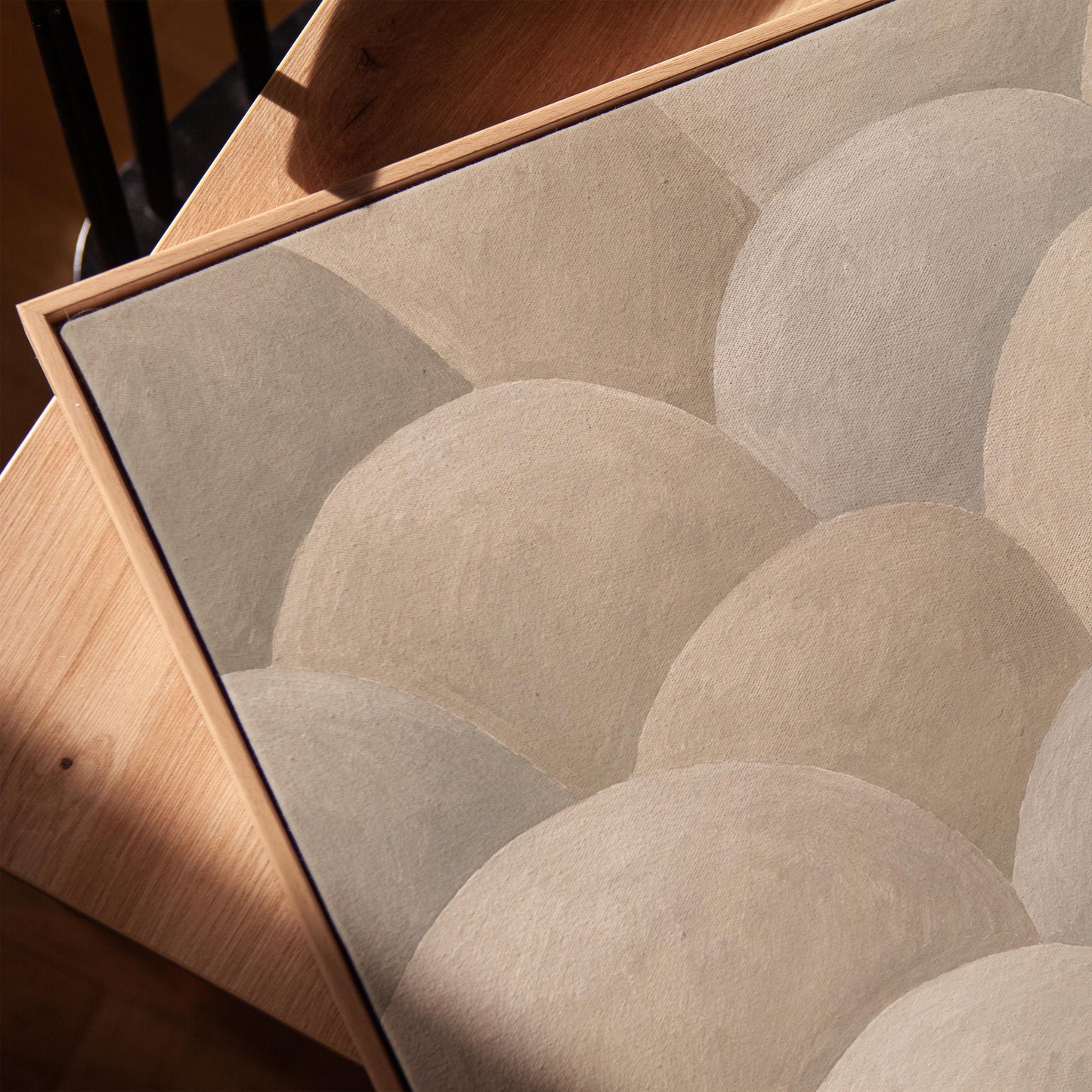 Rows of soft dome shapes in stone gray and beige, canvas print in a warm, minimally styled interior