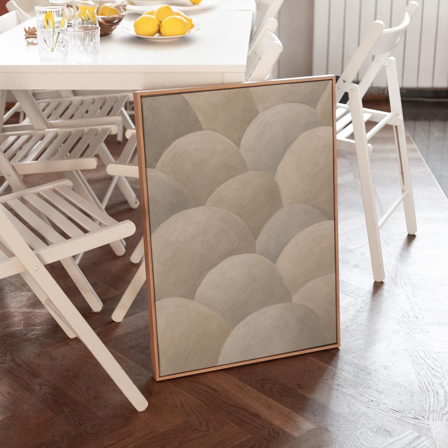 Rows of soft dome shapes in stone gray and beige, canvas wall art seen in a warm interior with natural light