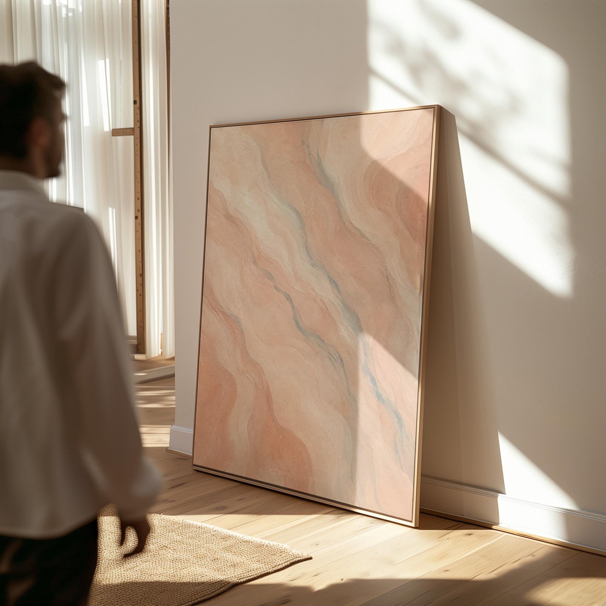 Soft flowing waves in peach blush and gray pastel, canvas print presented in a light, minimal room
