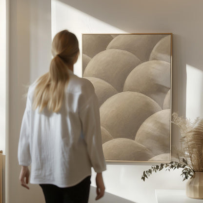 Rows of shaded dome shapes in deep taupe, canvas print on a quiet wall in a considered interior