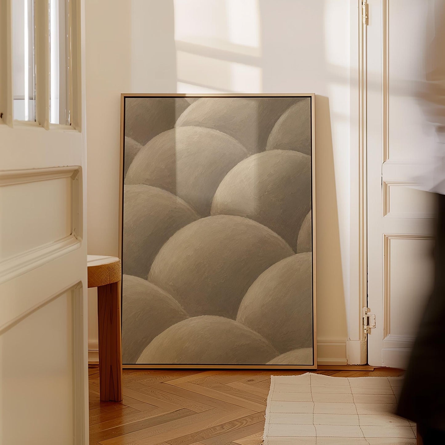 Rows of shaded dome shapes in deep taupe, canvas wall art styled against a soft white wall