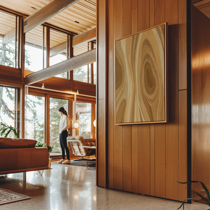 Concentric swirling lines in amber and caramel, canvas print hanging in a calm, modern living space