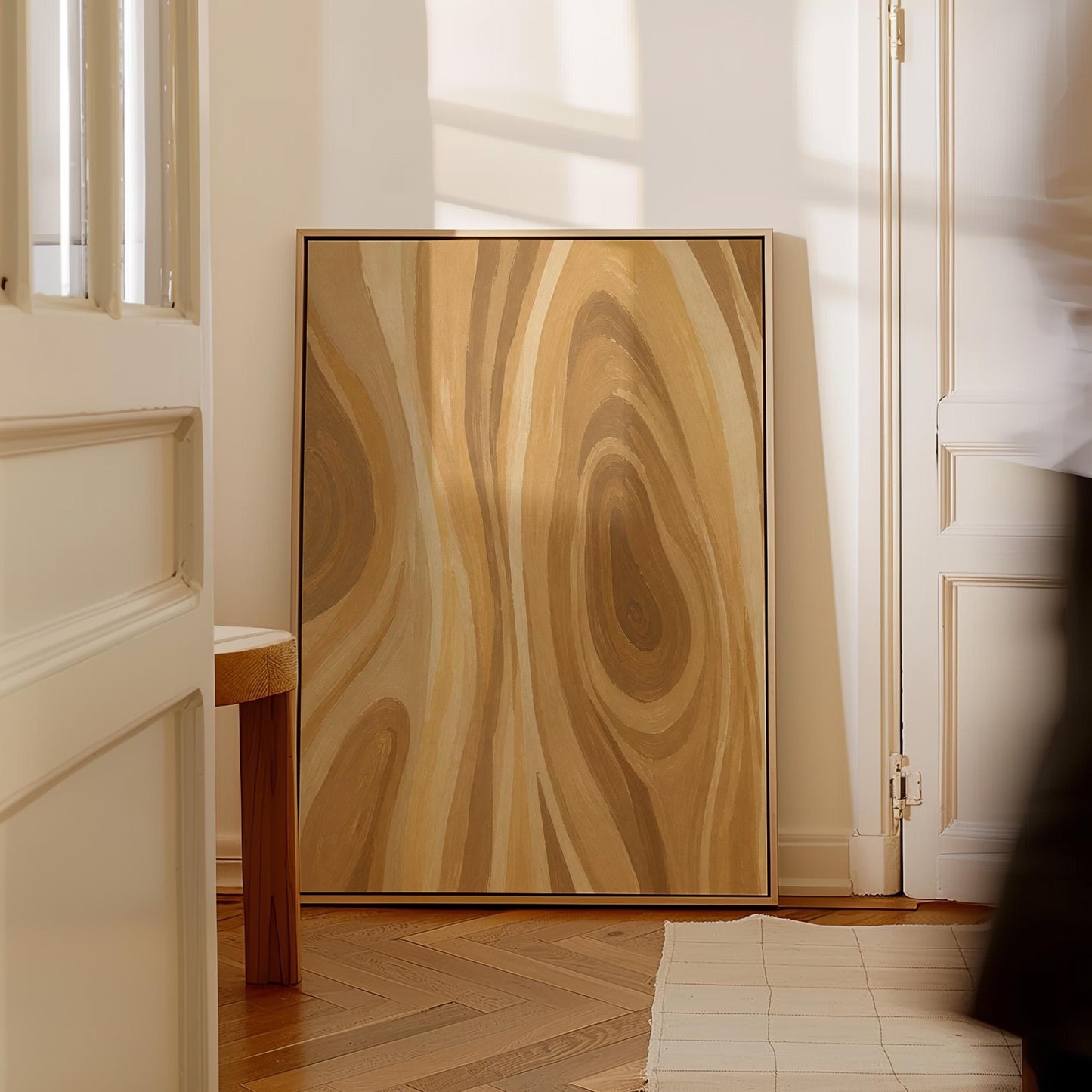 Concentric swirling lines in amber and caramel, canvas wall art on a quiet wall in a considered interior