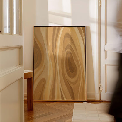 Concentric swirling lines in amber and caramel, canvas wall art on a quiet wall in a considered interior
