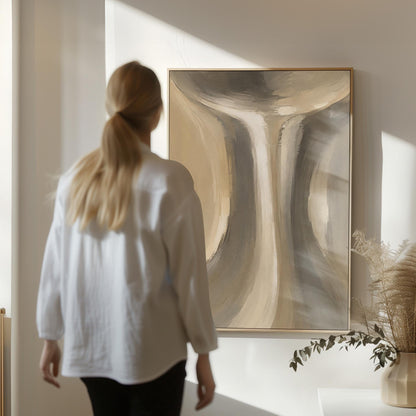 Elegant hourglass curve form in gray and taupe, canvas print displayed on a neutral wall in a styled interior