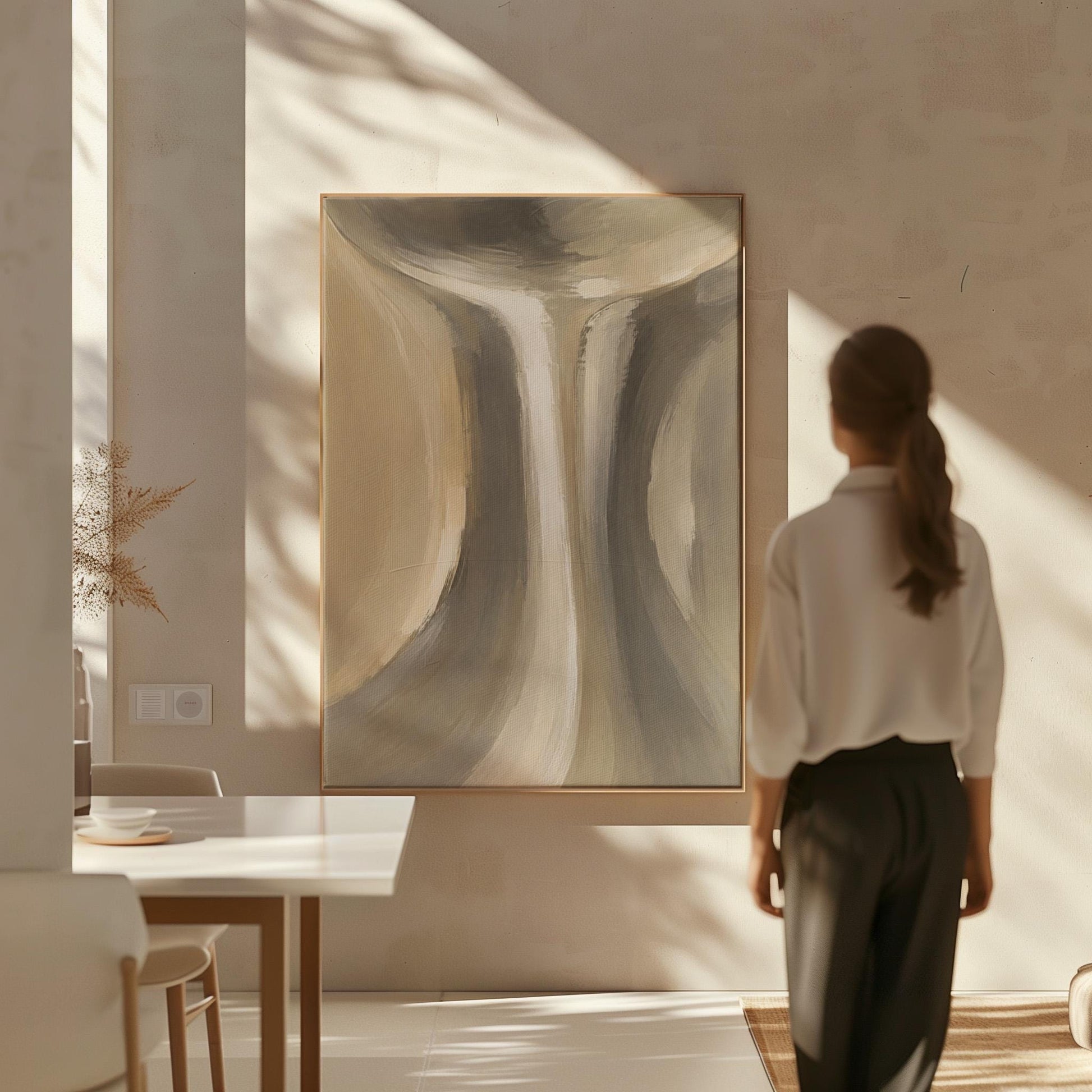 Elegant hourglass curve form in gray and taupe, canvas wall art on a quiet wall in a considered interior