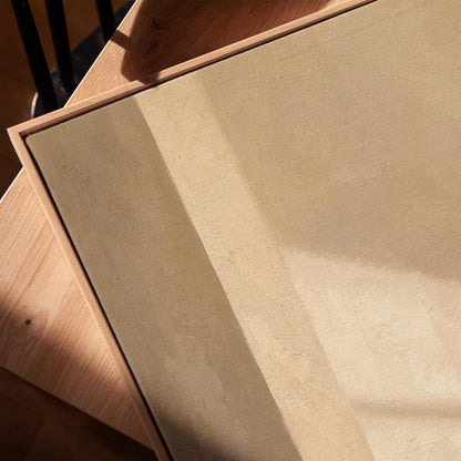 Vertical bands of light and shadow on warm beige, canvas print in a warm, minimally styled interior