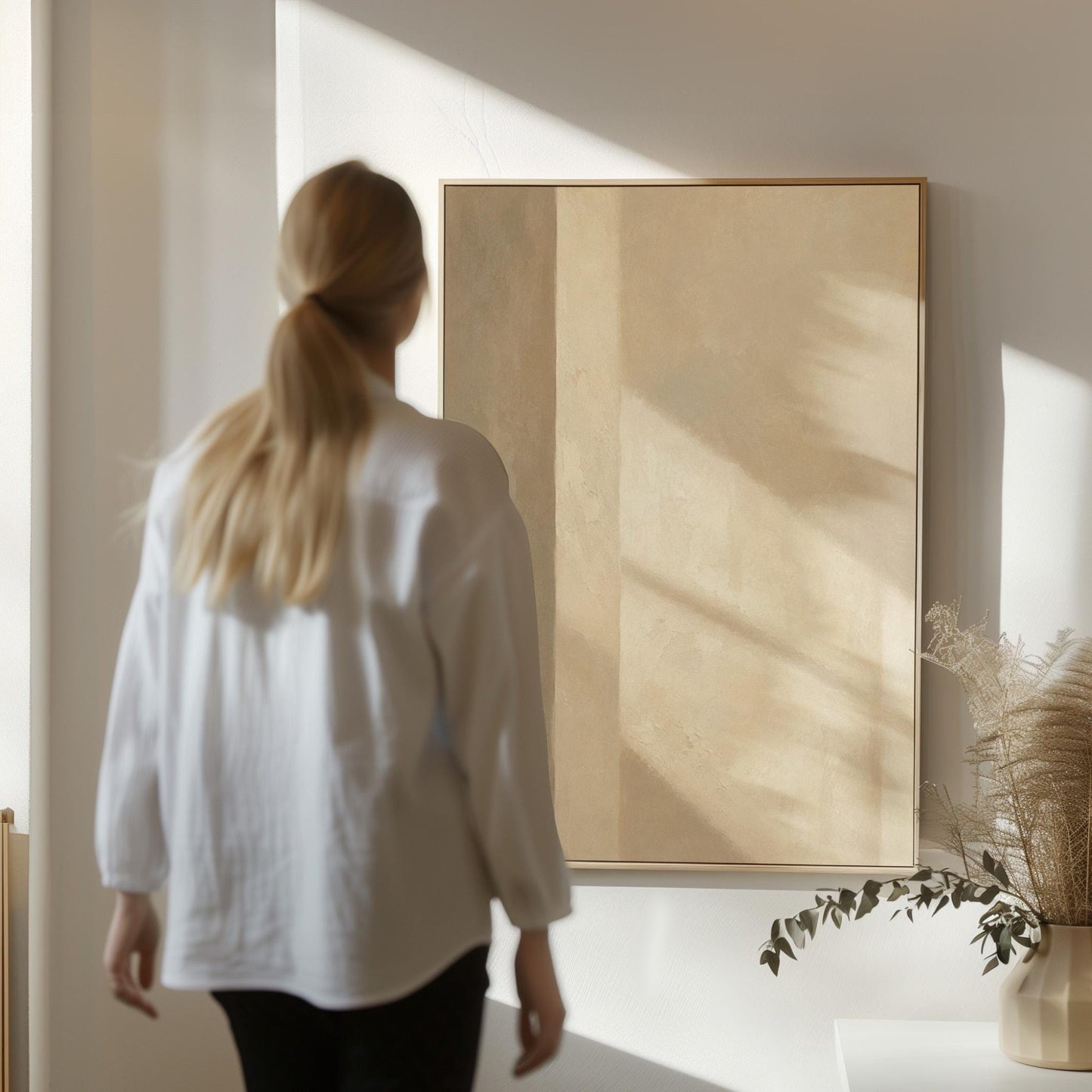 Vertical bands of light and shadow on warm beige, canvas print shown in a sunlit, contemporary room