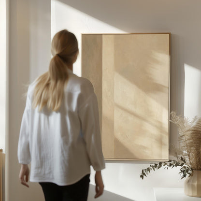Vertical bands of light and shadow on warm beige, canvas print shown in a sunlit, contemporary room