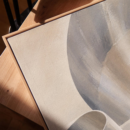 Graceful ribbon curves in silver and pale blue, canvas print in a warm, minimally styled interior