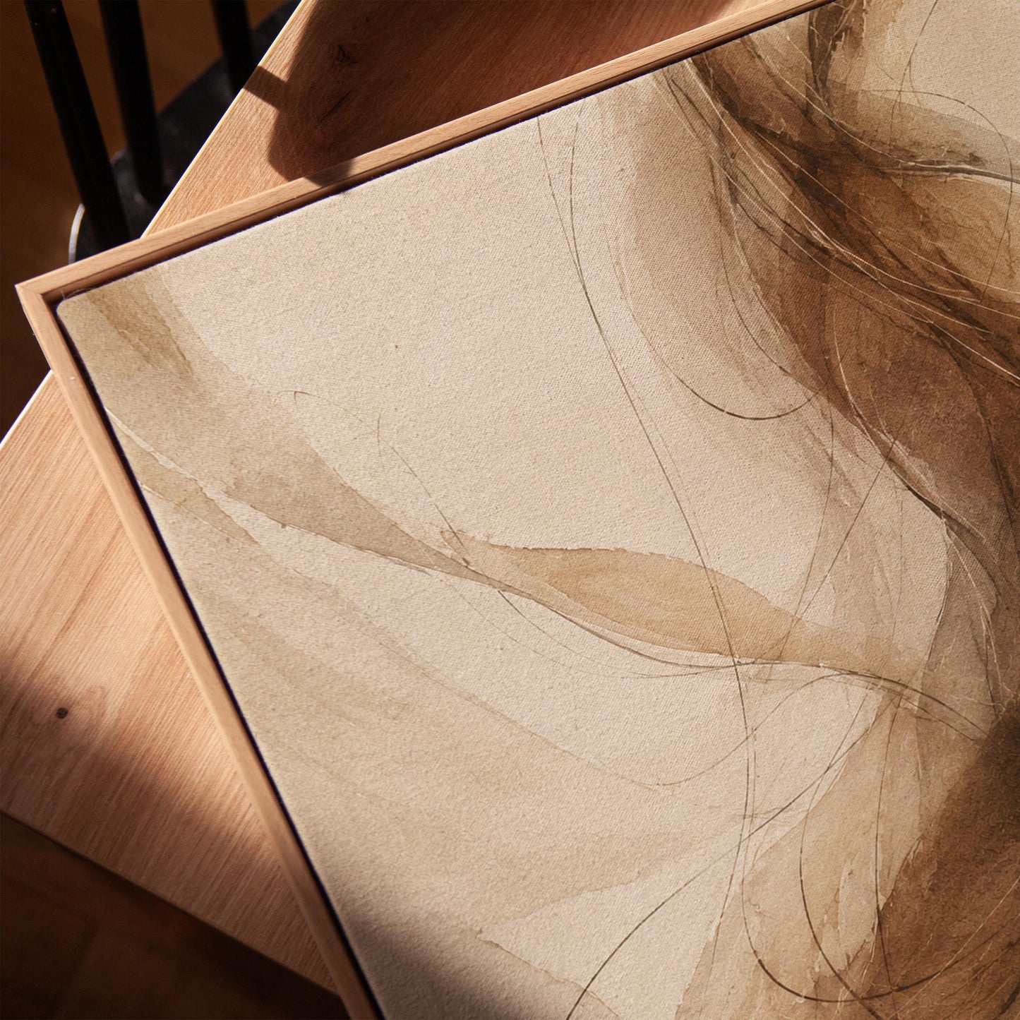 Wispy brown strands flowing across cream background, canvas print in a warm, minimally styled interior