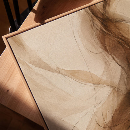 Wispy brown strands flowing across cream background, canvas print in a warm, minimally styled interior