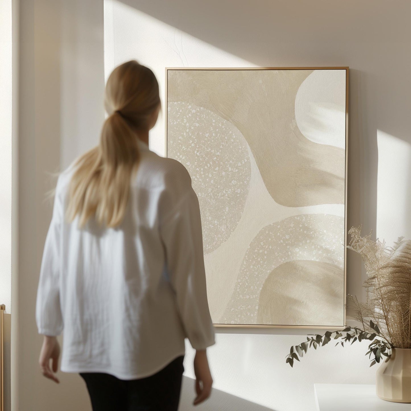 Soft speckled organic shapes in pearl and cream, canvas print styled against a soft white wall