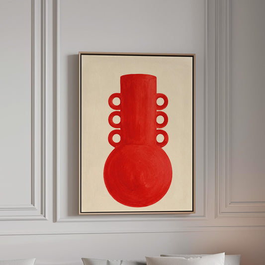 Bold red vessel with ring handles on cream background, canvas print in a bright room with natural daylight
