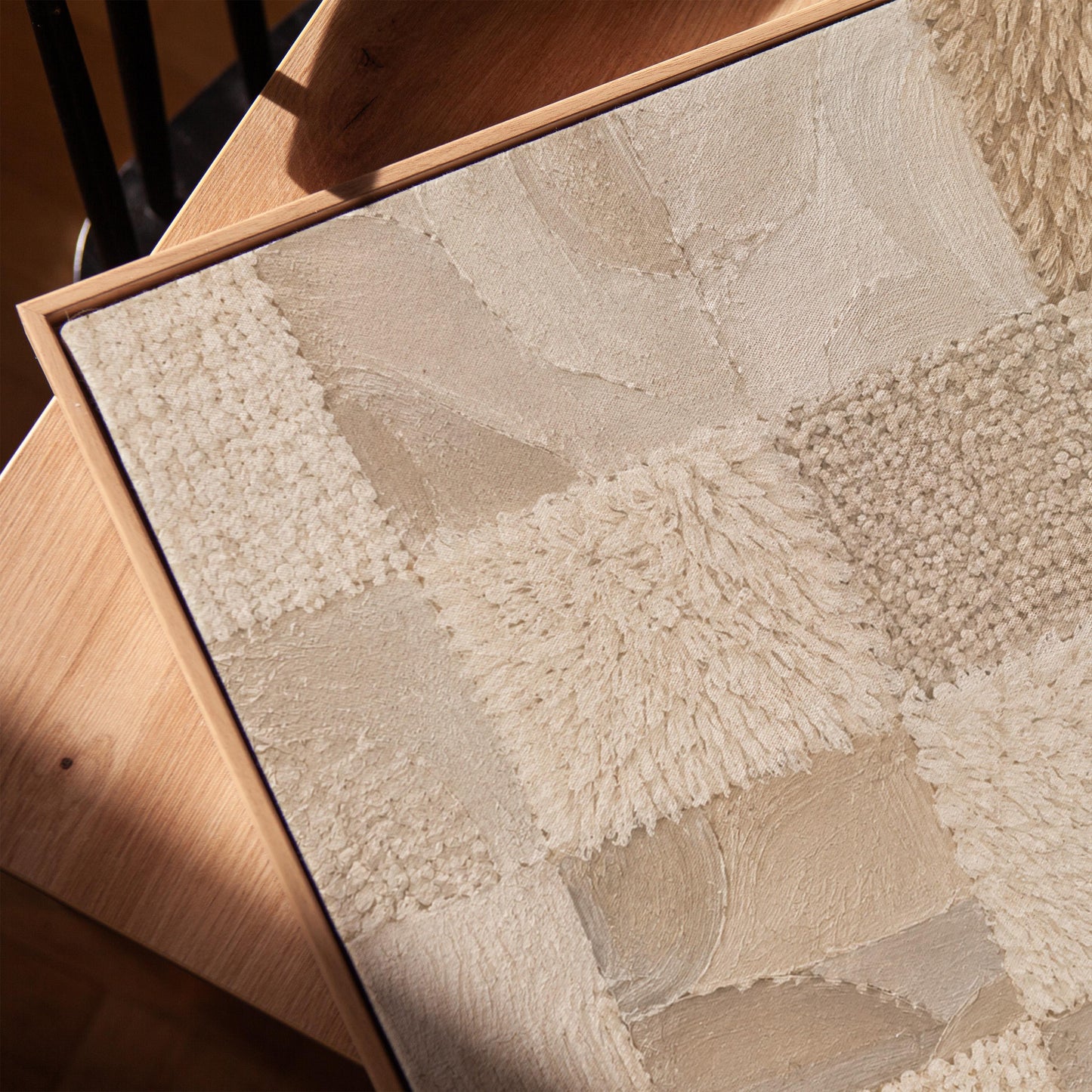 Checkered patchwork of soft cream and beige squares, canvas print in a warm, minimally styled interior