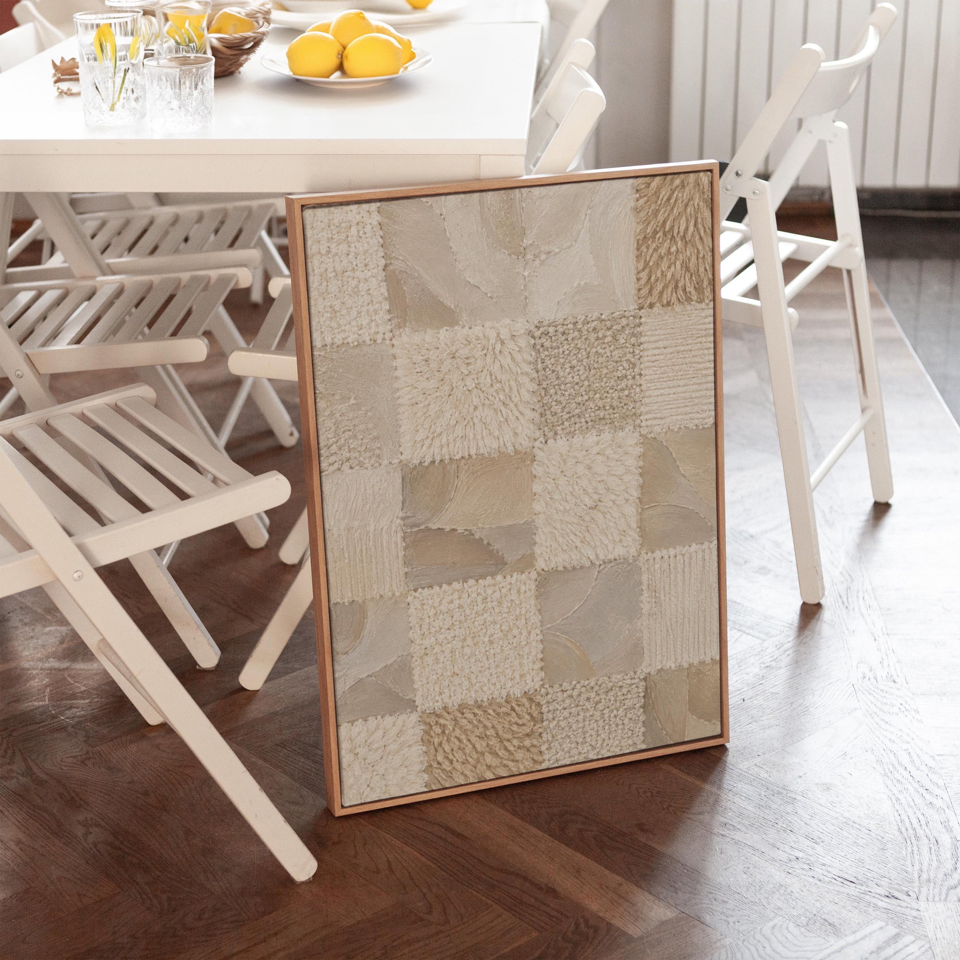 Checkered patchwork of soft cream and beige squares, canvas wall art seen in a warm interior with natural light