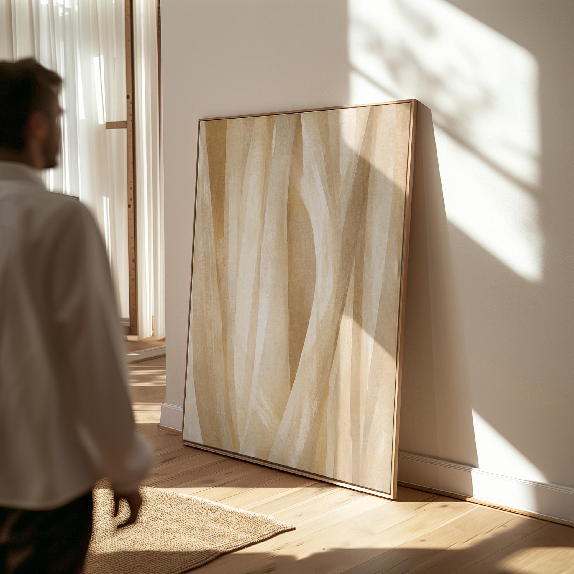 Golden beige ribbon strands flowing diagonally, canvas print styled against a soft white wall
