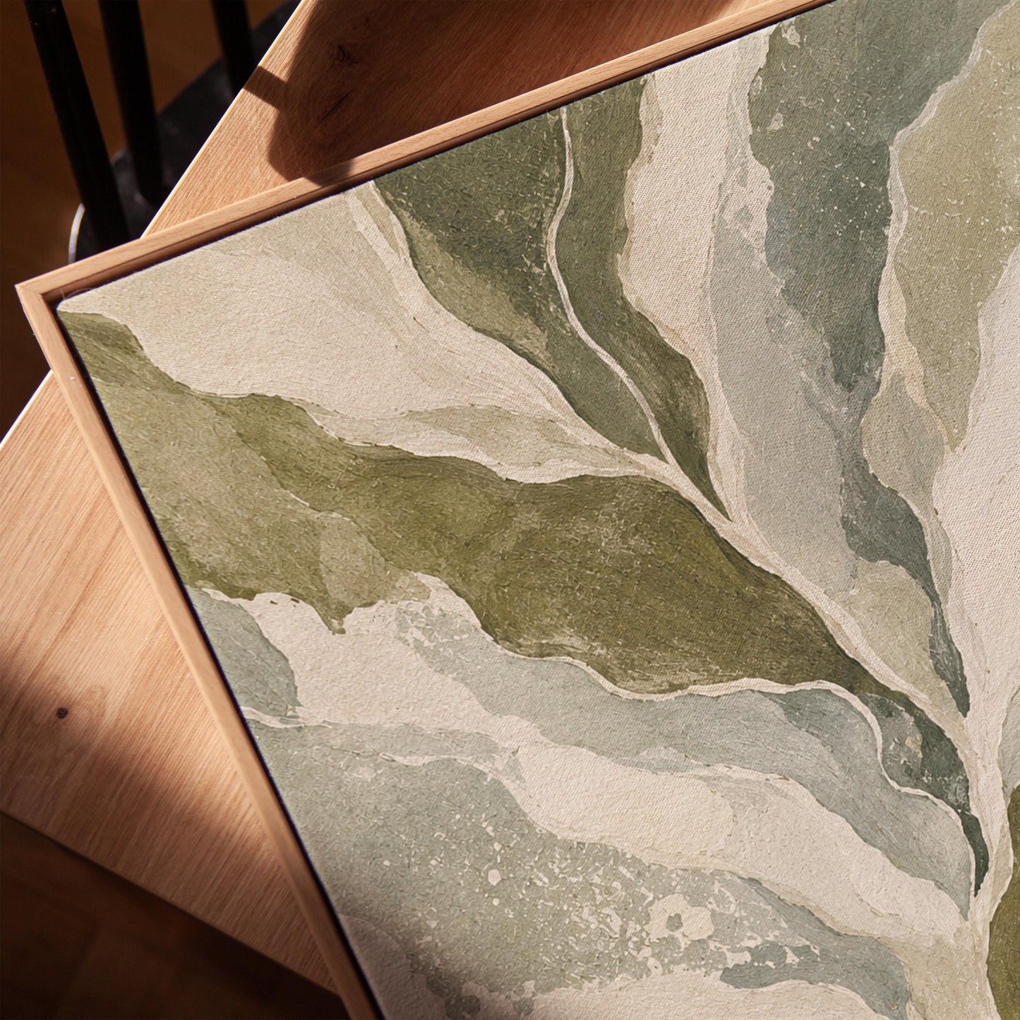 Flowing olive green leaves with soft marbled look, canvas print in a warm, minimally styled interior