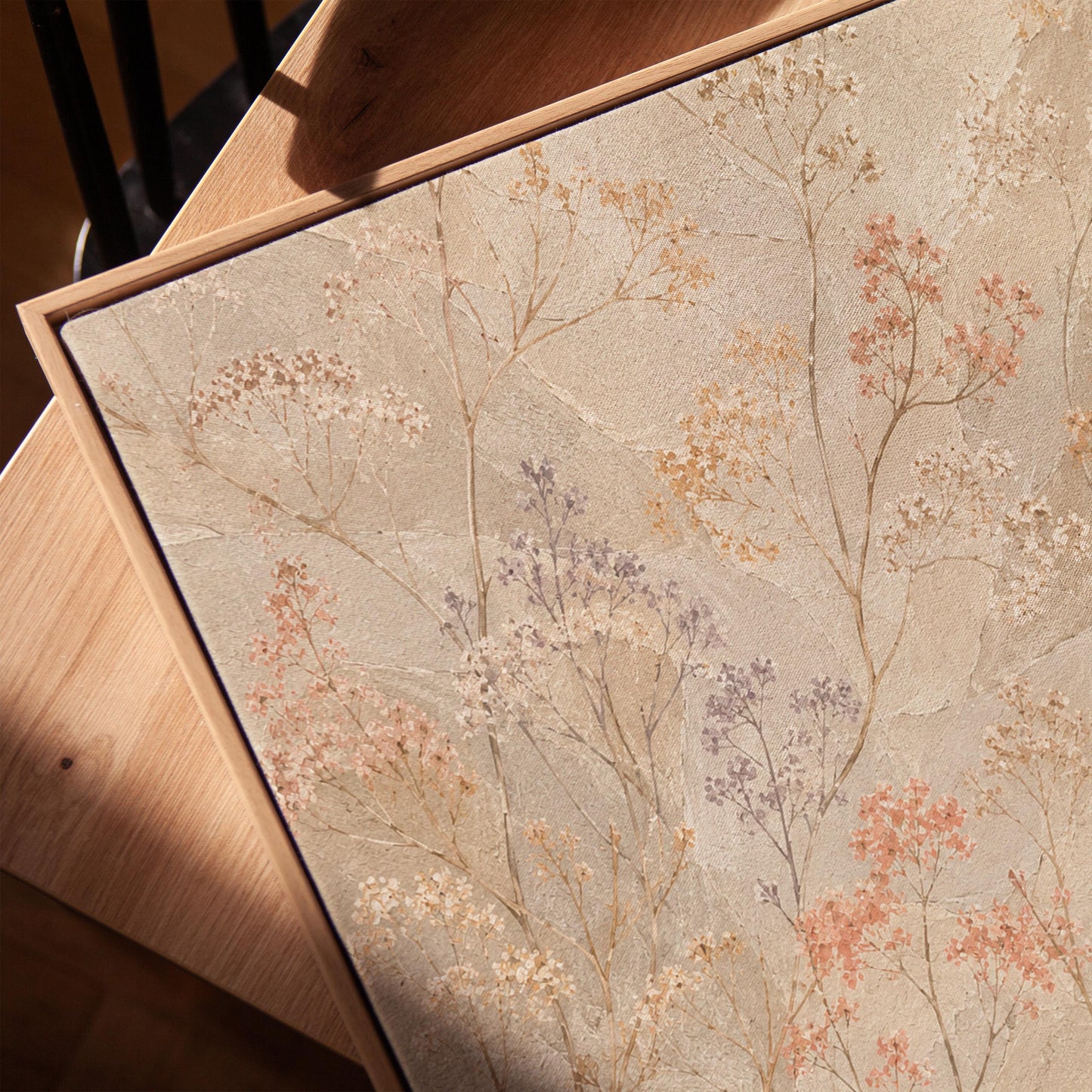 Fine sprigs and tiny blooms scattered on cream, canvas print in a warm, minimally styled interior