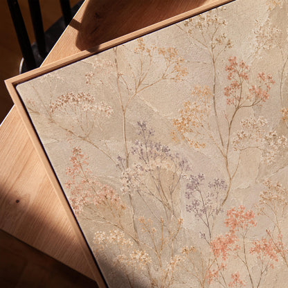 Fine sprigs and tiny blooms scattered on cream, canvas print in a warm, minimally styled interior