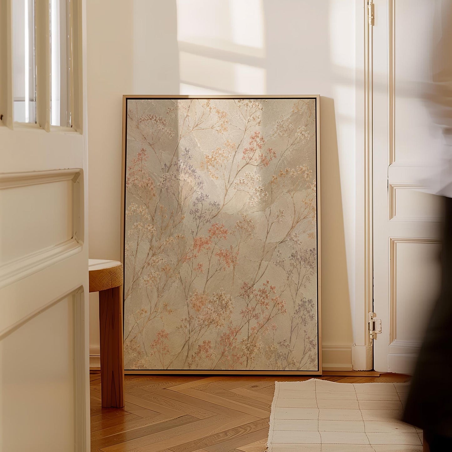 Fine sprigs and tiny blooms scattered on cream, canvas wall art styled against a soft white wall