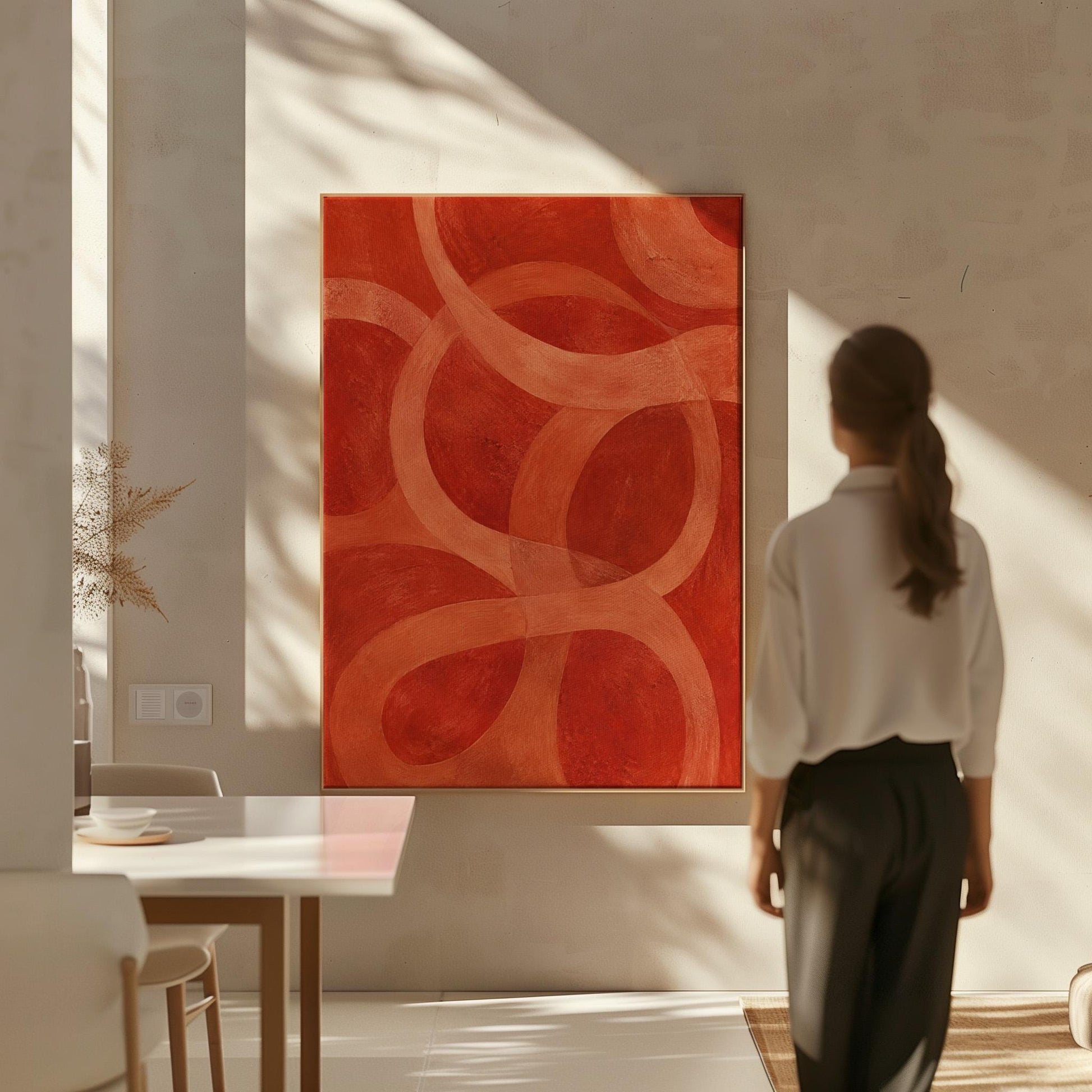 Interlocking loop rings in burnt orange and rust, canvas wall art presented in a light, minimal room