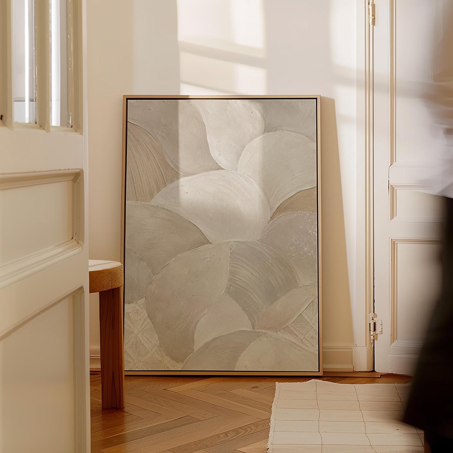 Sweeping layered petal curves in cream tones, canvas print hanging in a calm, modern living space