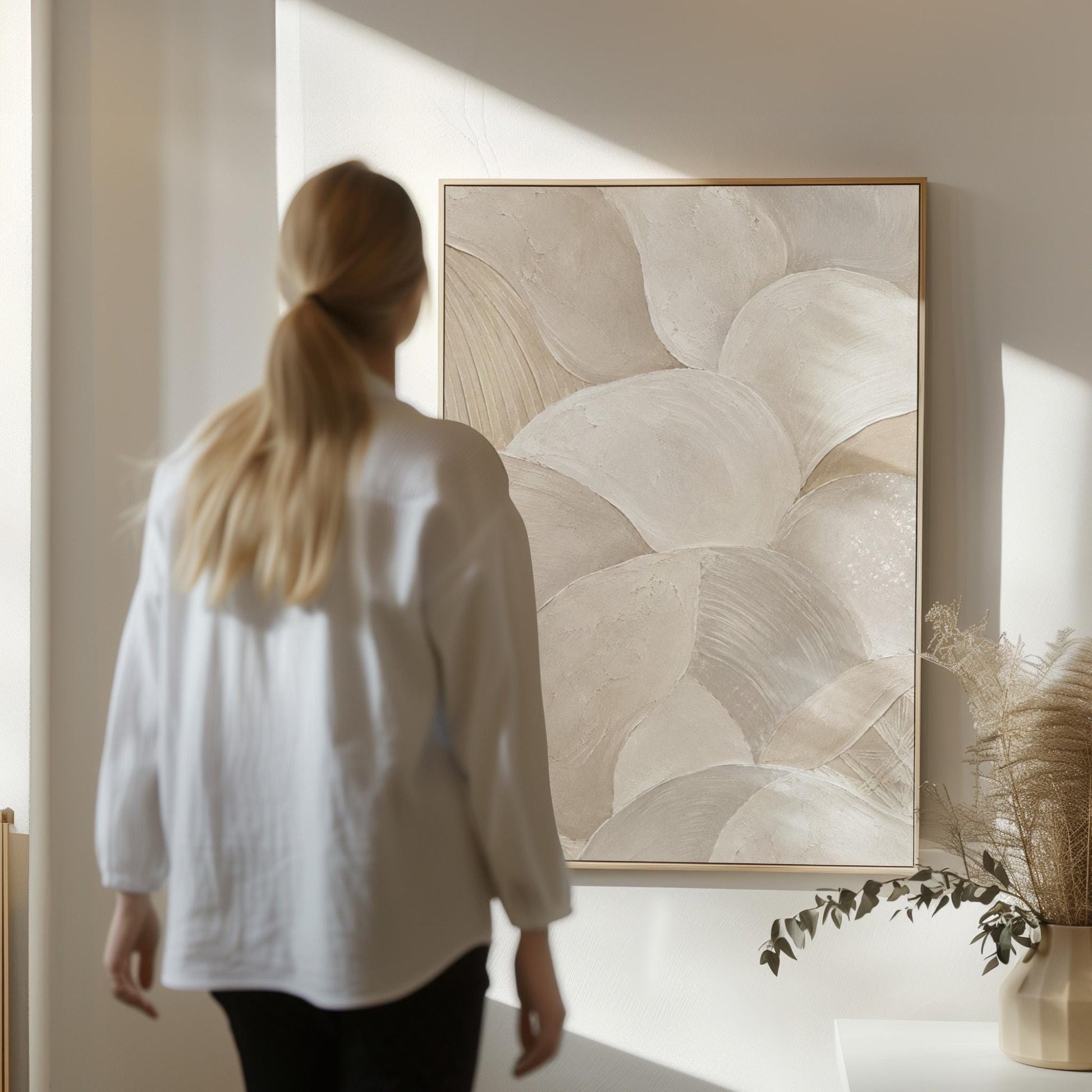Sweeping layered petal curves in cream tones, canvas wall art on a quiet wall in a considered interior