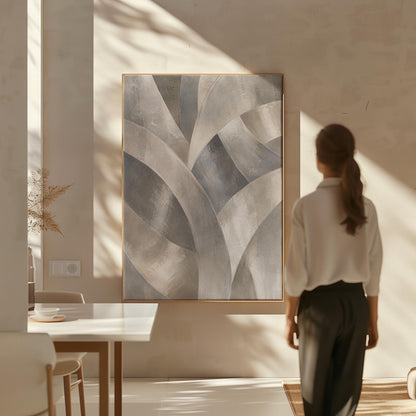 Crossing curved silver bands in graceful motion, canvas print hanging in a calm, modern living space