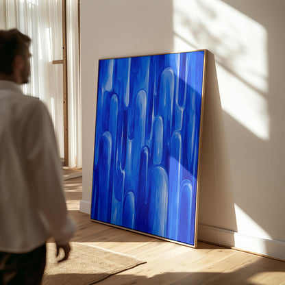 Vertical cobalt streaks like flowing rain, canvas print seen in a warm interior with natural light