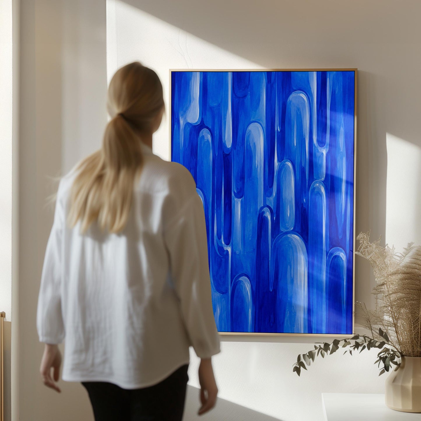 Vertical cobalt streaks like flowing rain, canvas wall art styled against a soft white wall