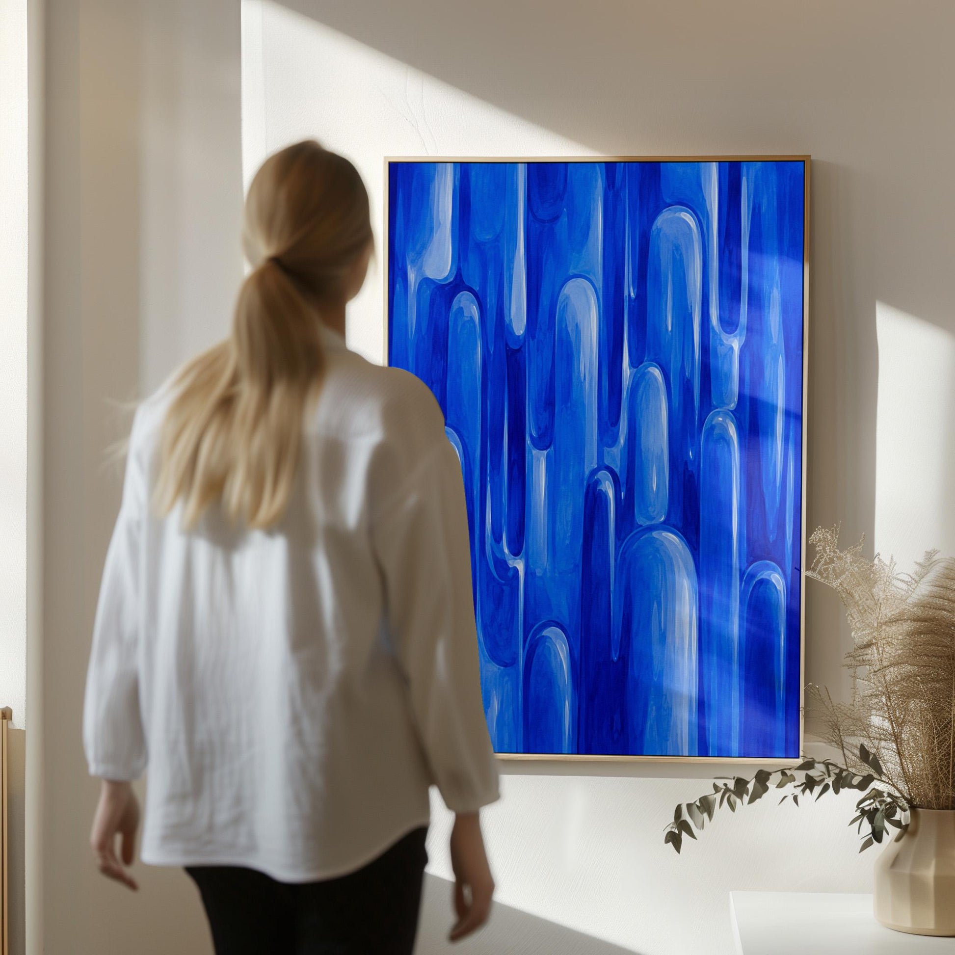 Vertical cobalt streaks like flowing rain, canvas wall art styled against a soft white wall