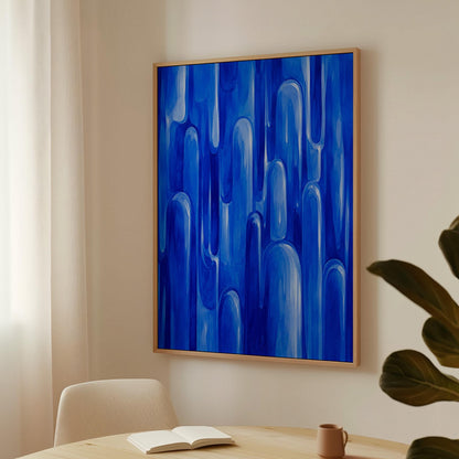 Vertical cobalt streaks like flowing rain, canvas wall art seen in a warm interior with natural light