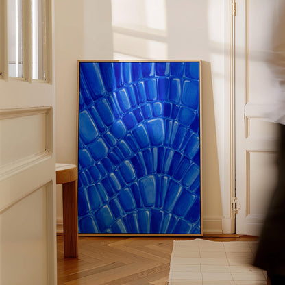 Fan arcs of cobalt mosaic pebbles, canvas wall art hanging in a calm, modern living space