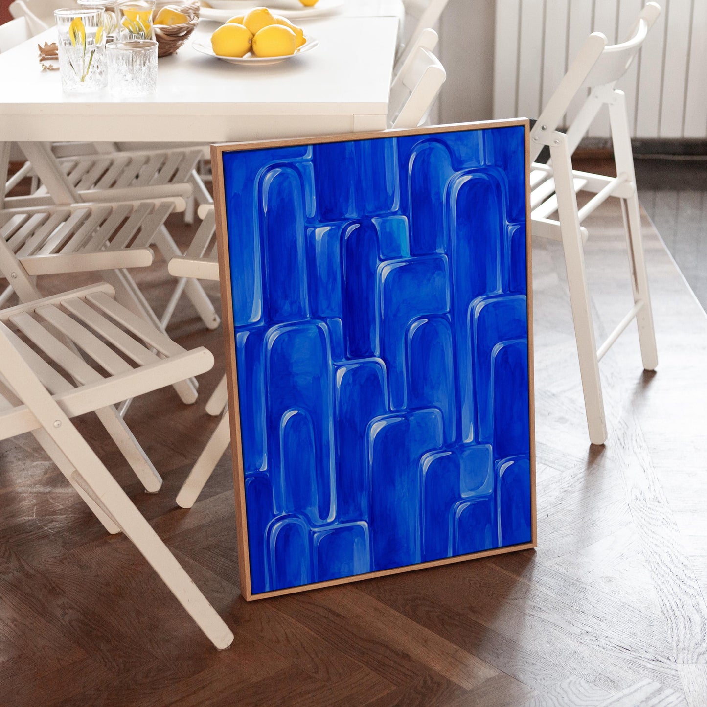 Rounded arch tile shapes in vivid cobalt blue, canvas print hanging in a calm, modern living space