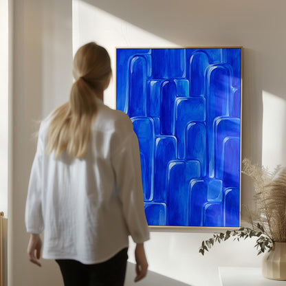 Rounded arch tile shapes in vivid cobalt blue, canvas print displayed on a neutral wall in a styled interior