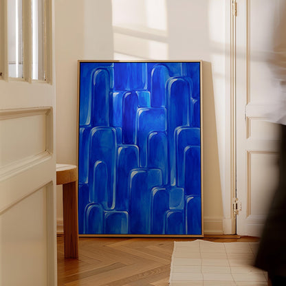 Rounded arch tile shapes in vivid cobalt blue, canvas wall art on a quiet wall in a considered interior