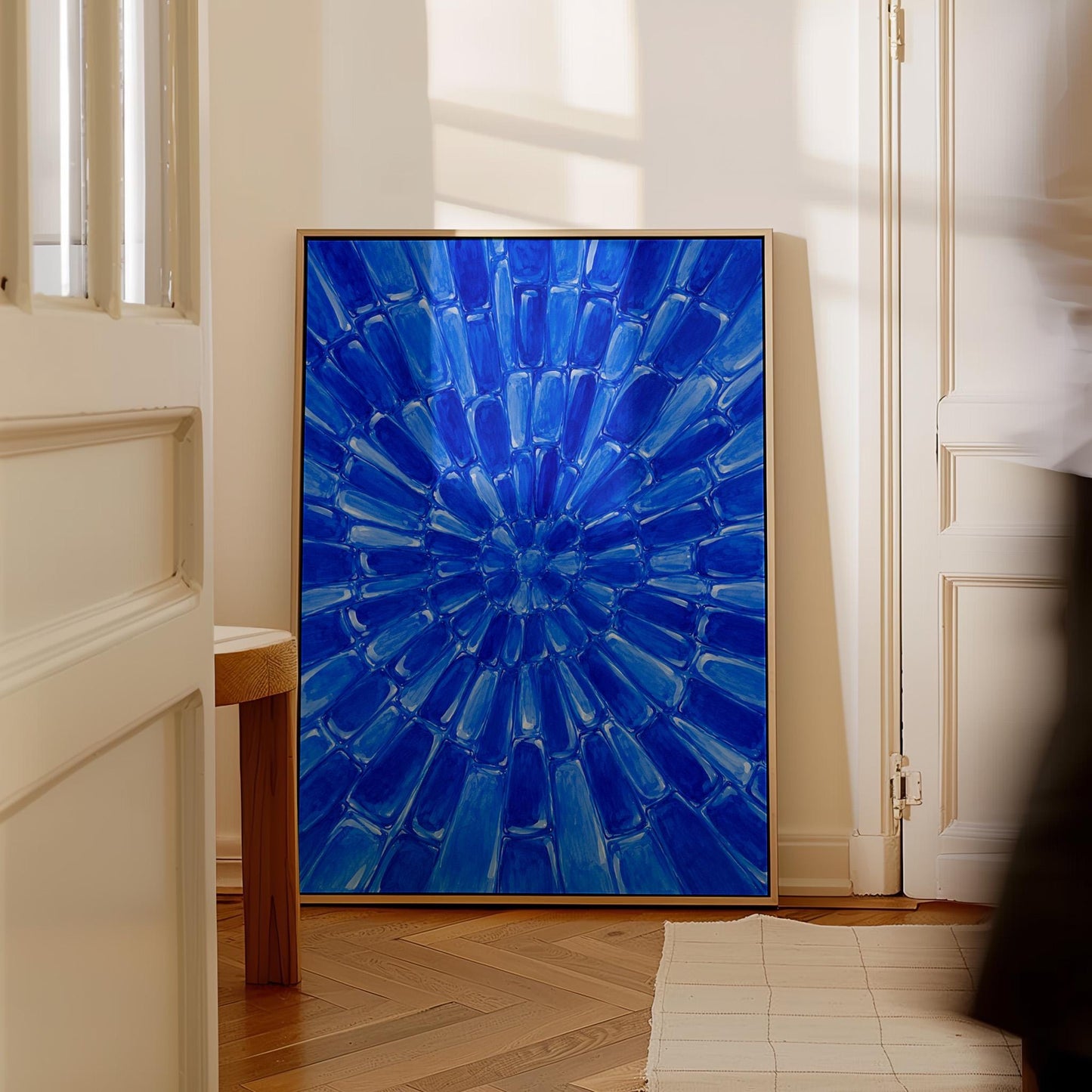 Radial starburst rays in electric cobalt blue, canvas wall art hanging in a calm, modern living space